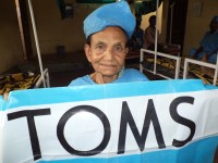 Asha Lata Showing TOMS flag, before her cataract surgery