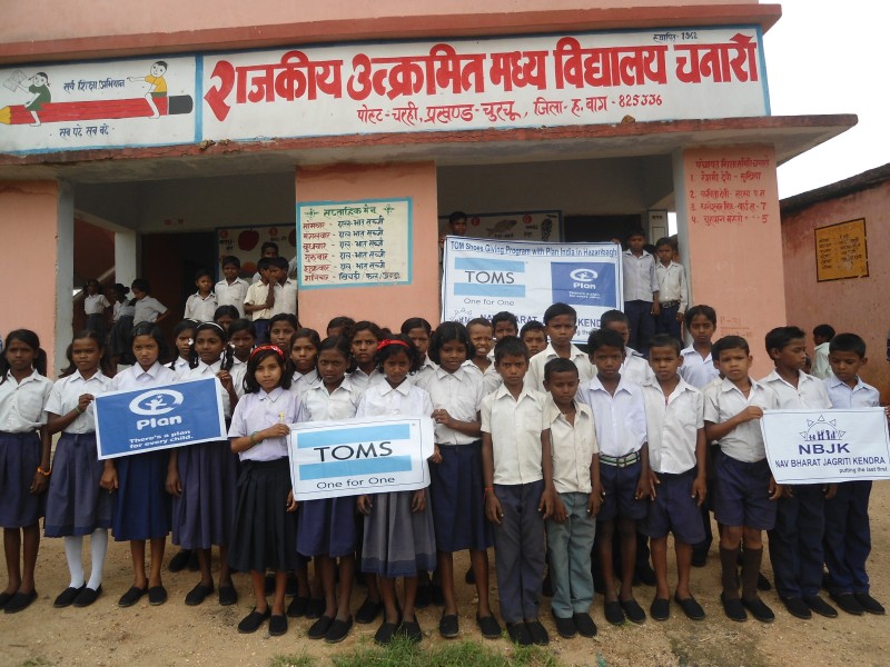 govt school children holding toms banner after getting shoes